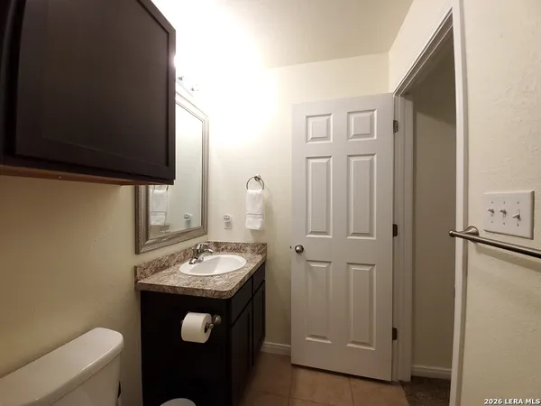 a bathroom with a granite countertop toilet sink and shower