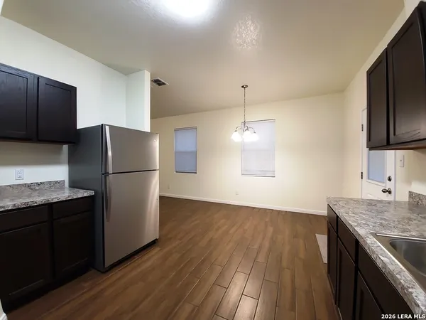 a kitchen with a refrigerator and a sink