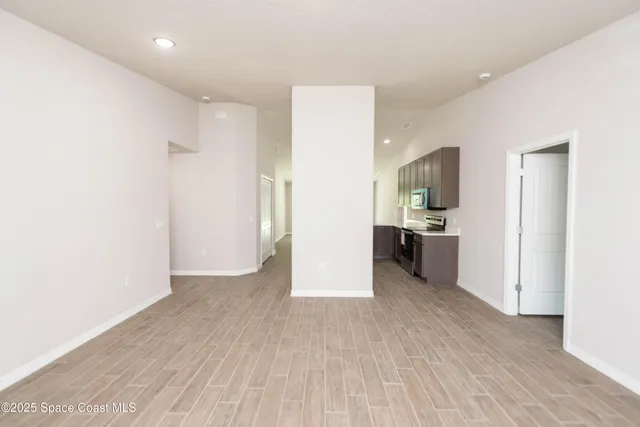 a view of a kitchen with a sink and a refrigerator