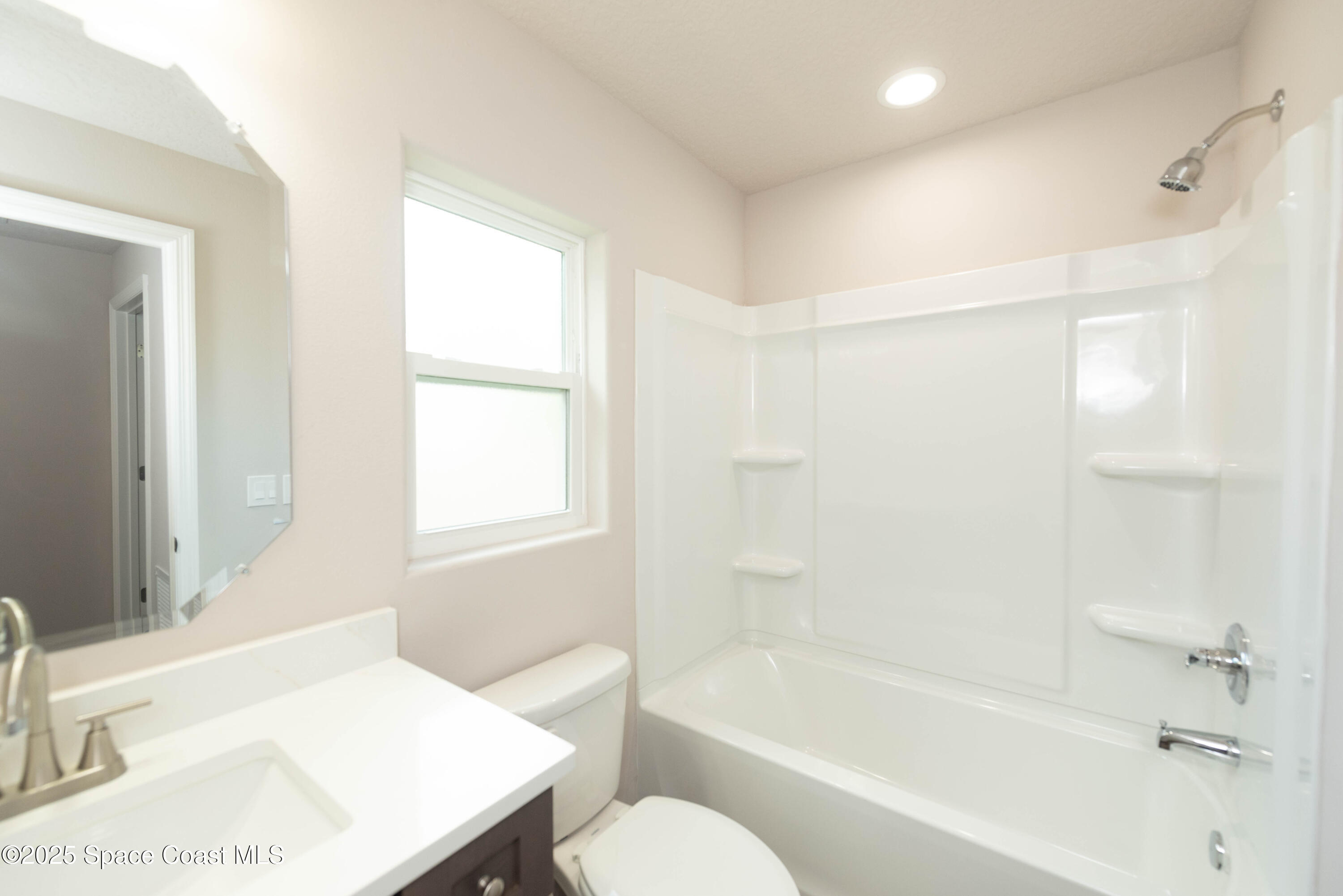 250 Frederick Street Southwest Palm Bay, FL 32908 - Photo 23 of 45 a bathroom with a sink toilet bathtub and vanity