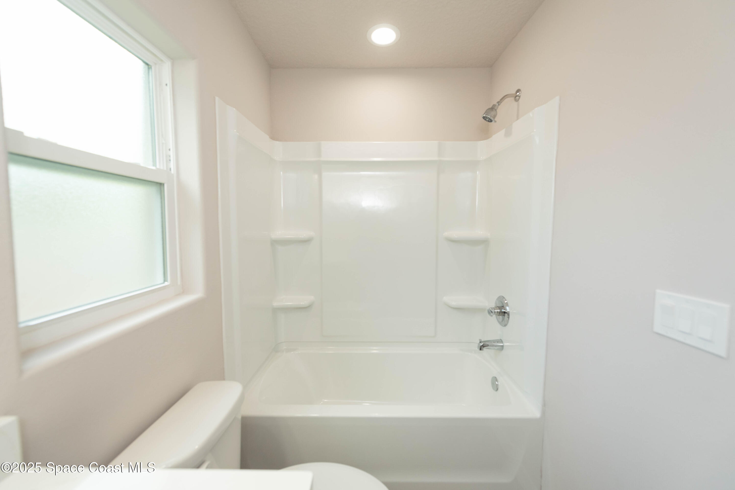 250 Frederick Street Southwest Palm Bay, FL 32908 - Photo 25 of 45 a bathroom with a bathtub and a shower