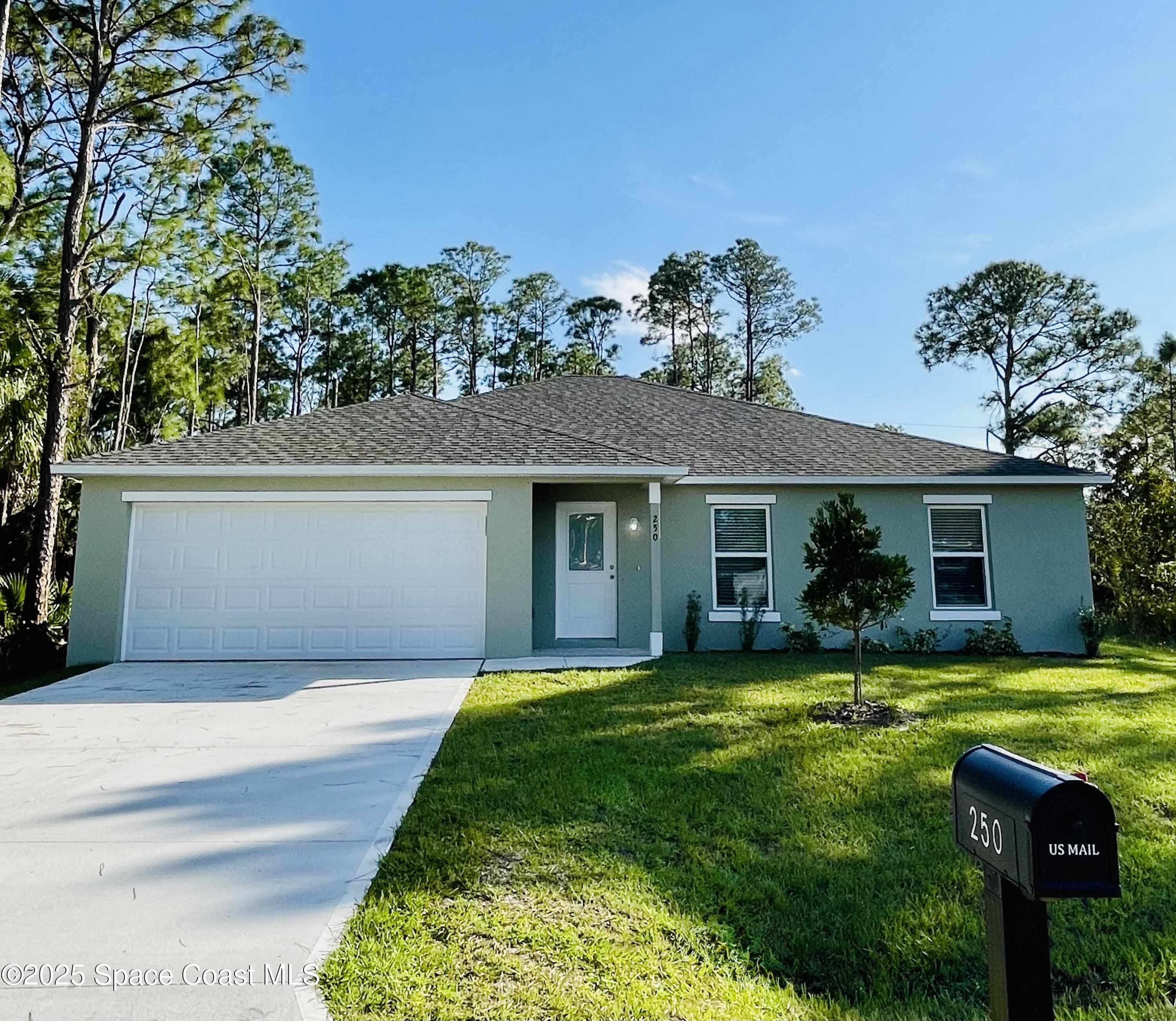 250 Frederick Street Southwest Palm Bay, FL 32908 - Photo 3 of 45 a front view of house with yard and green space