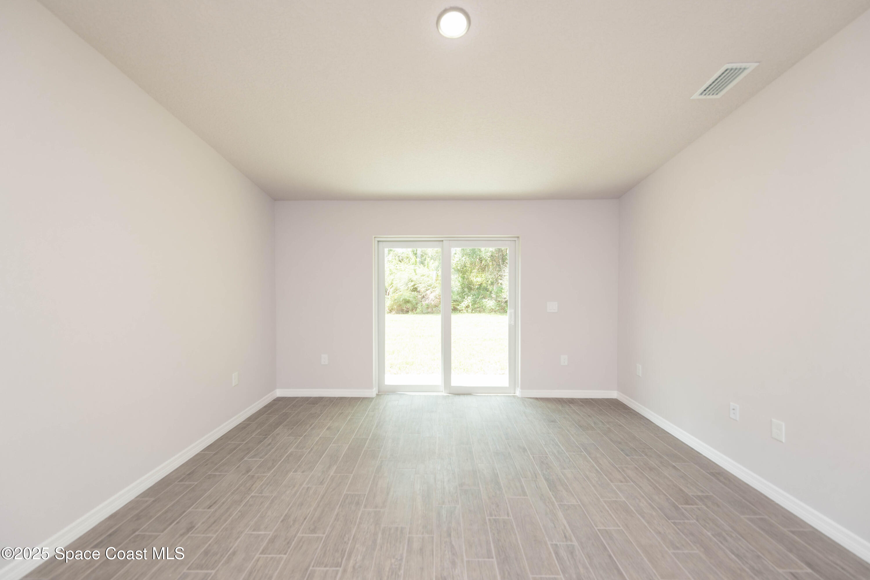 250 Frederick Street Southwest Palm Bay, FL 32908 - Photo 38 of 45 an empty room with wooden floor and windows