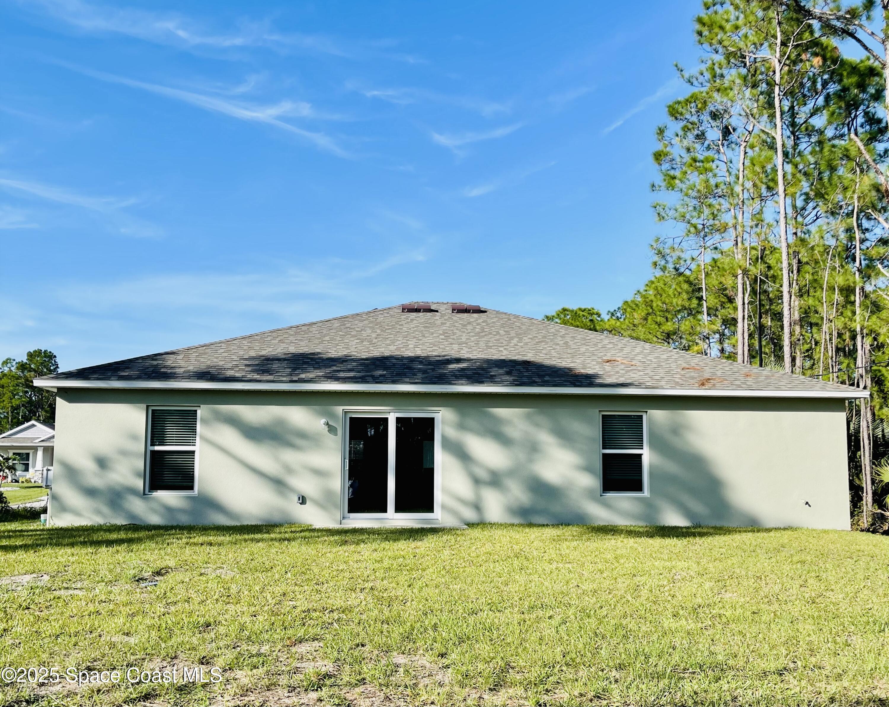 250 Frederick Street Southwest Palm Bay, FL 32908 - Photo 44 of 45 a front view of a house with a garden