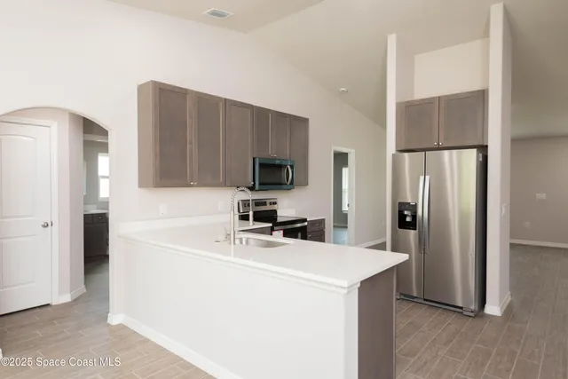 a kitchen with a refrigerator sink and microwave