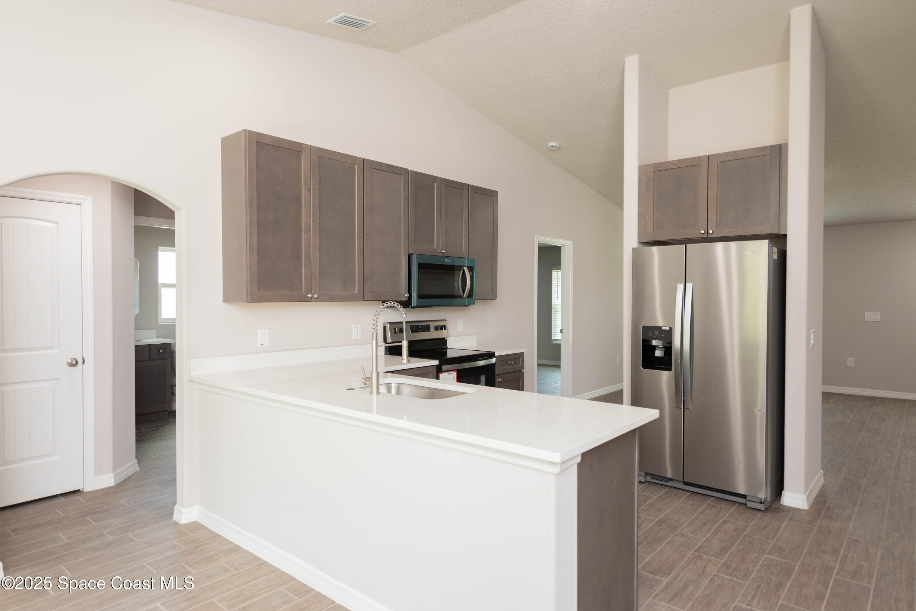 250 Frederick Street Southwest Palm Bay, FL 32908 - Photo 9 of 45 a kitchen with a refrigerator sink and microwave