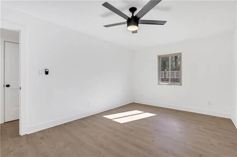2396 Lawrenceville Highway, Unit V Decatur, GA 30033 - Photo 19 of 27 an empty room with a window and a fan