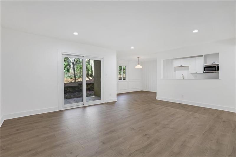 2396 Lawrenceville Highway, Unit V Decatur, GA 30033 - Photo 2 of 27 an empty room with wooden floor and windows
