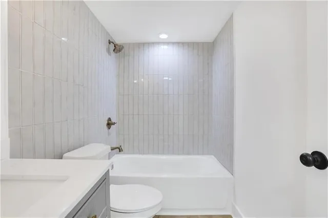 a bathroom with a toilet a sink and bathtub