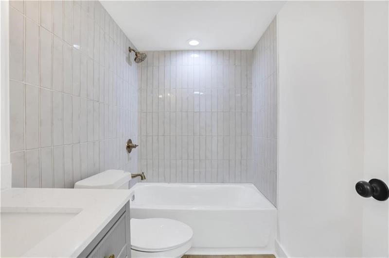 2396 Lawrenceville Highway, Unit V Decatur, GA 30033 - Photo 23 of 27 a bathroom with a toilet a sink and bathtub