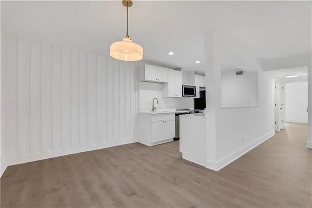 a view of a kitchen with an empty space and a window
