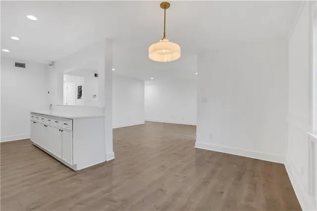 a view of a room with wooden floor and windows