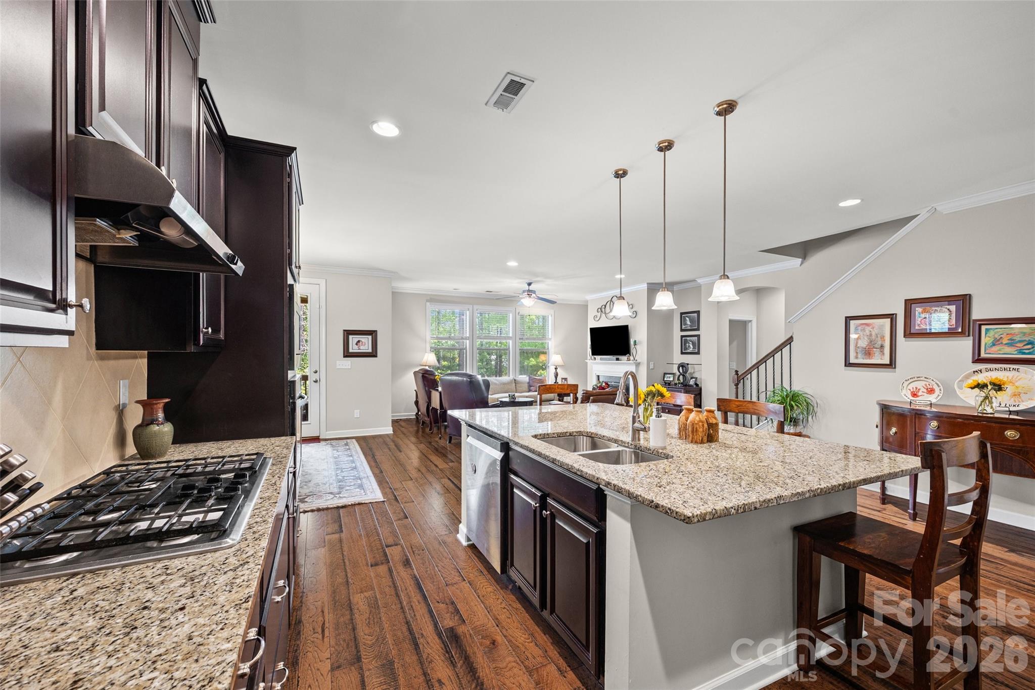2054 Lometa Road York, SC 29745 - Photo 11 of 45 a kitchen with stainless steel appliances granite countertop a stove and a view of living room