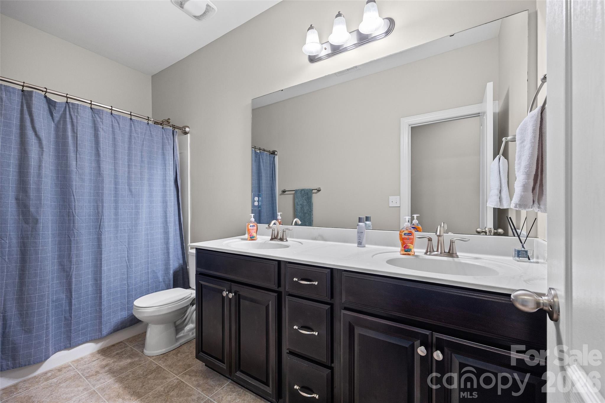 2054 Lometa Road York, SC 29745 - Photo 28 of 45 a bathroom with a double vanity sink toilet and a mirror