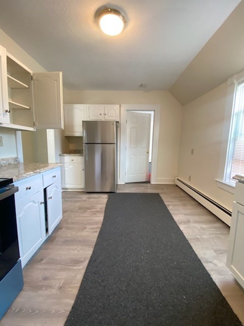 381 Broadway, Unit 2 Lynn, MA 01904 - Photo 2 of 7 a view of a kitchen with a sink dishwasher and a refrigerator