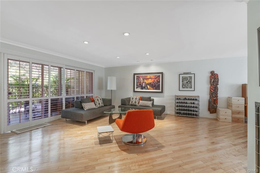 a living room with furniture a rug and a floor to ceiling window