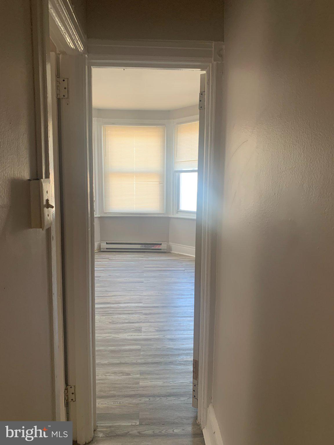 1026 Fillmore Street, Unit 2 Philadelphia, PA 19124 - Photo 5 of 7 Bright hallway leading to bathroom & large bedroom