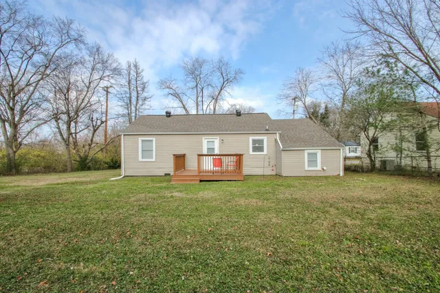 a front view of house with yard and trees