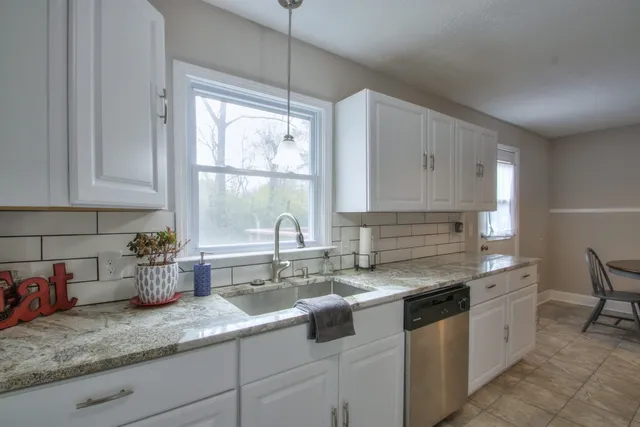 a kitchen with a sink stove and window