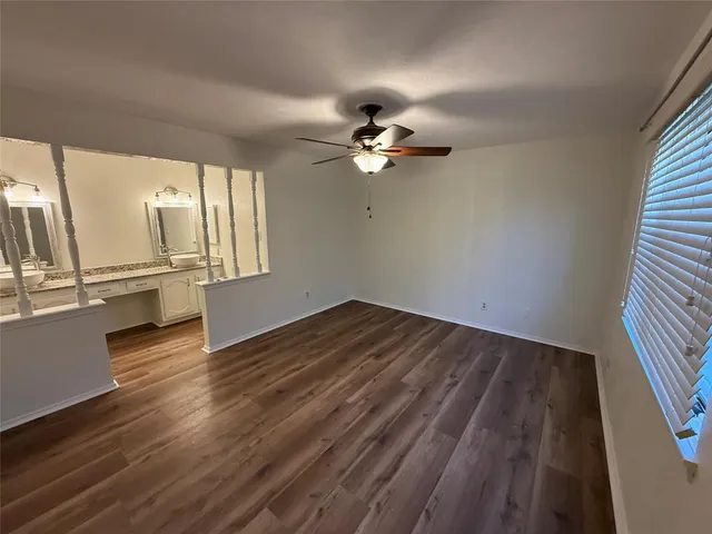 wooden floor in an empty room with a window