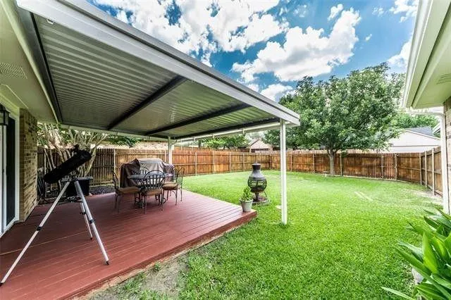 a view of a backyard with sitting area