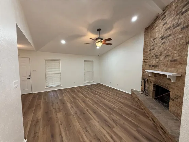 wooden floor in an empty room with a fireplace