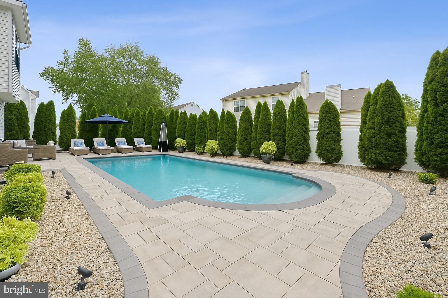 19 Phoenix Road Marlton, NJ 08053 - Photo 23 of 32 a view of a swimming pool with a yard and palm trees