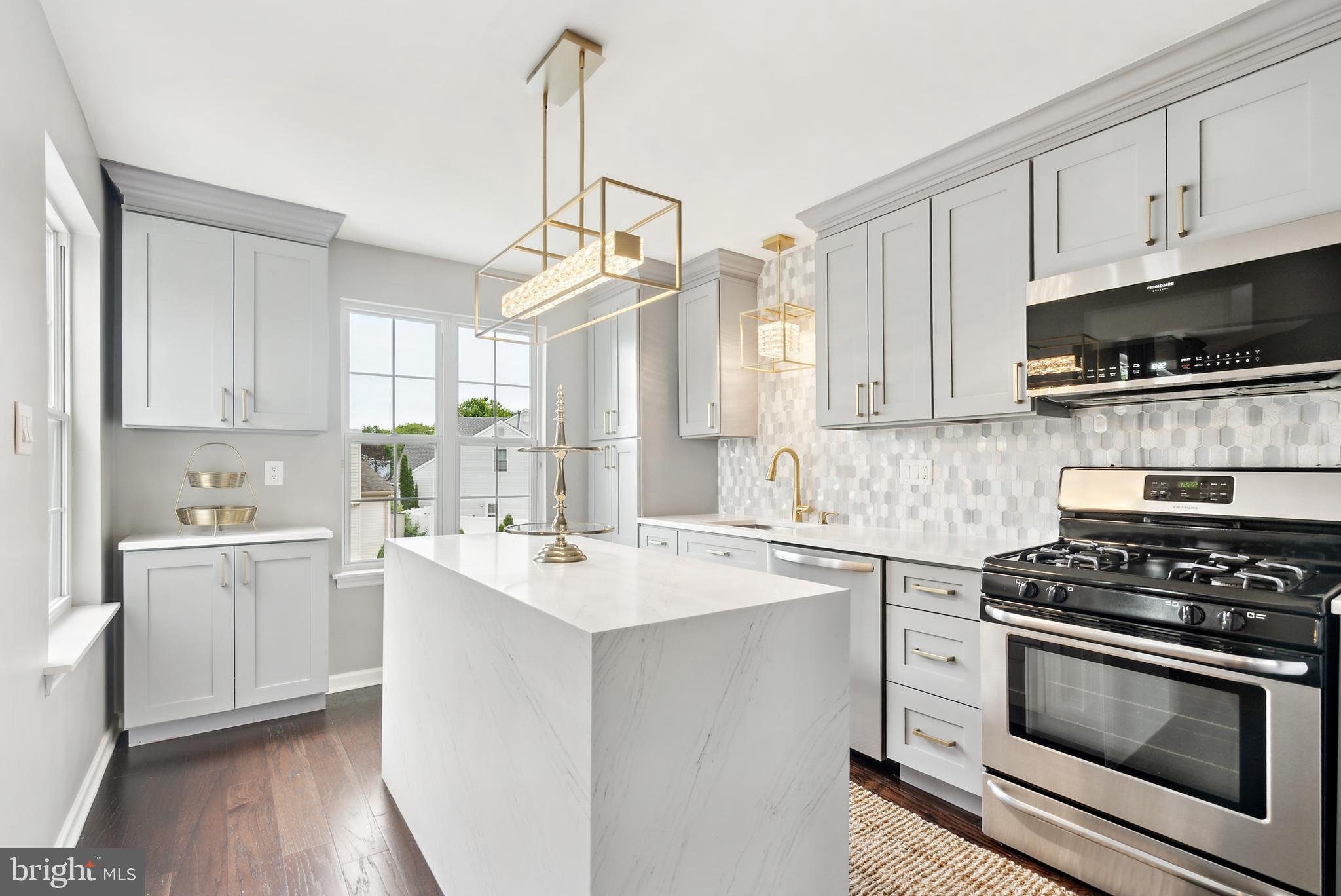 19 Phoenix Road Marlton, NJ 08053 - Photo 6 of 32 a kitchen with a sink stove top oven and cabinets