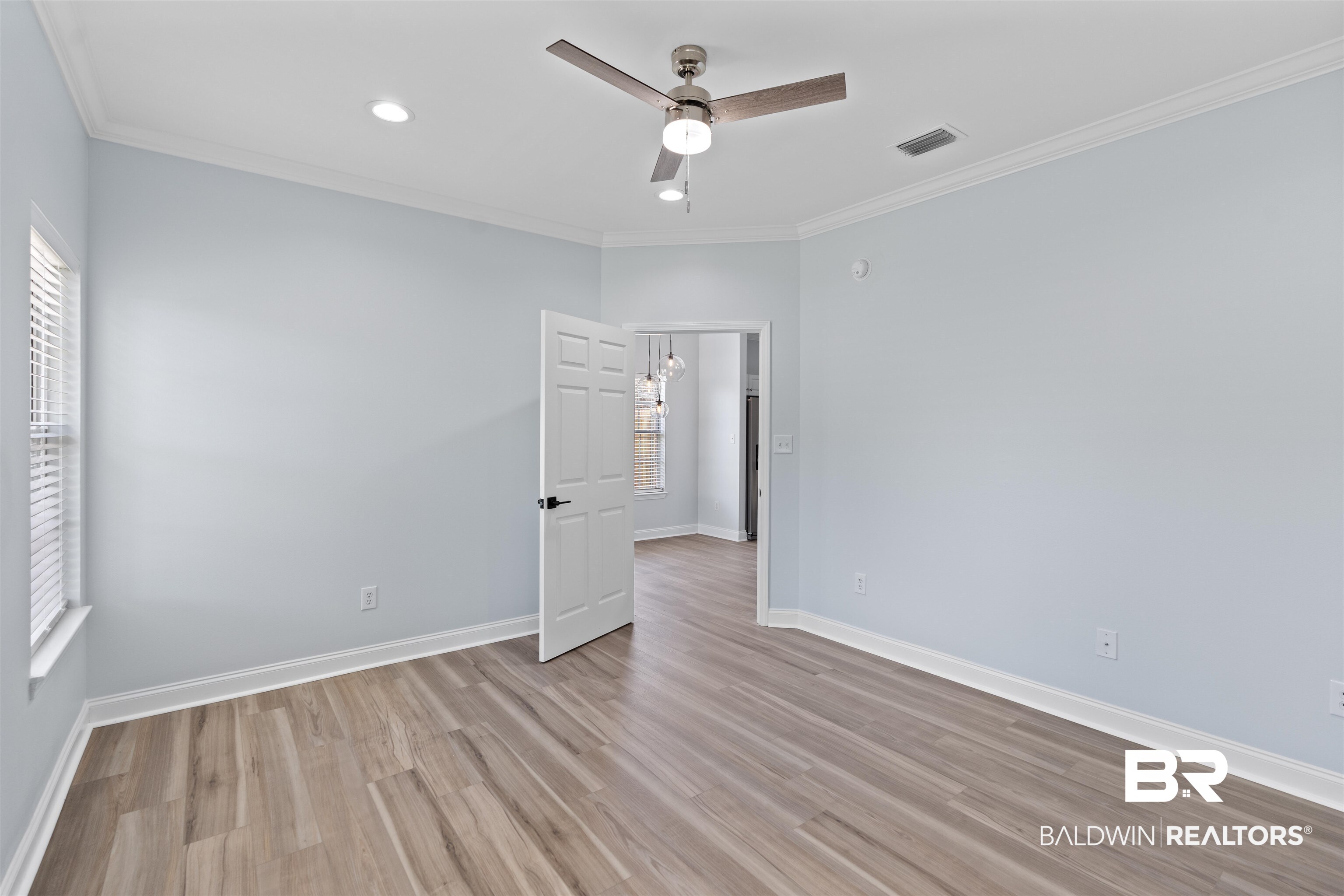 14947 Silveroaks Loop Silverhill, AL 36576 - Photo 15 of 24 Empty room with wood finished floors, ornamental molding, ceiling fan, and recessed lighting