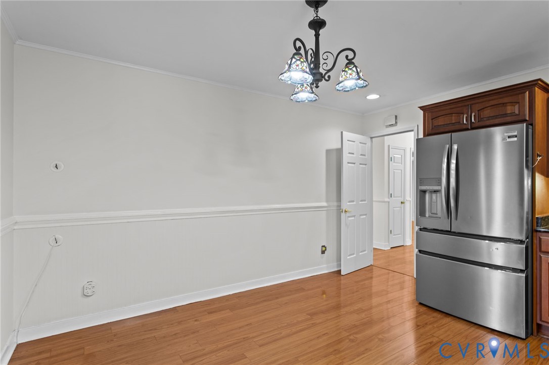 5359 Qualla Road Chesterfield, VA 23832 - Photo 15 of 49 a view of a kitchen with a refrigerator a ceiling fan and wooden floor
