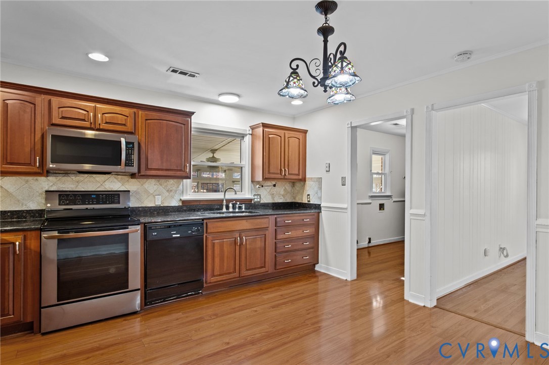 5359 Qualla Road Chesterfield, VA 23832 - Photo 17 of 49 a large kitchen with stainless steel appliances granite countertop a stove cabinets and wooden floor