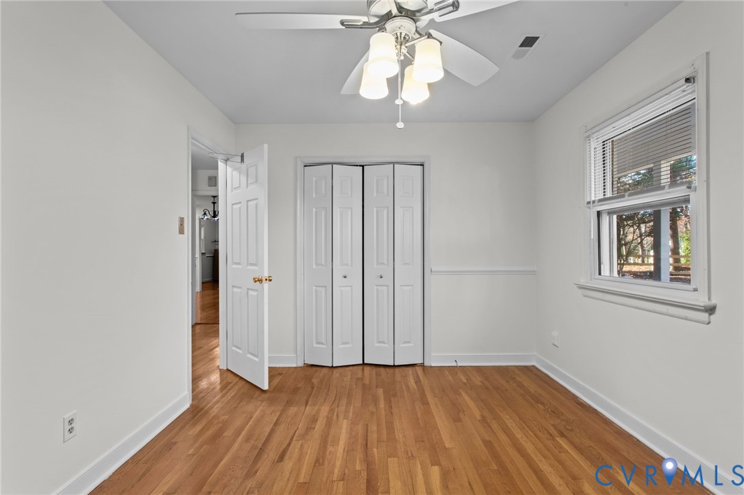 5359 Qualla Road Chesterfield, VA 23832 - Photo 21 of 49 a view of an empty room with wooden floor and a window