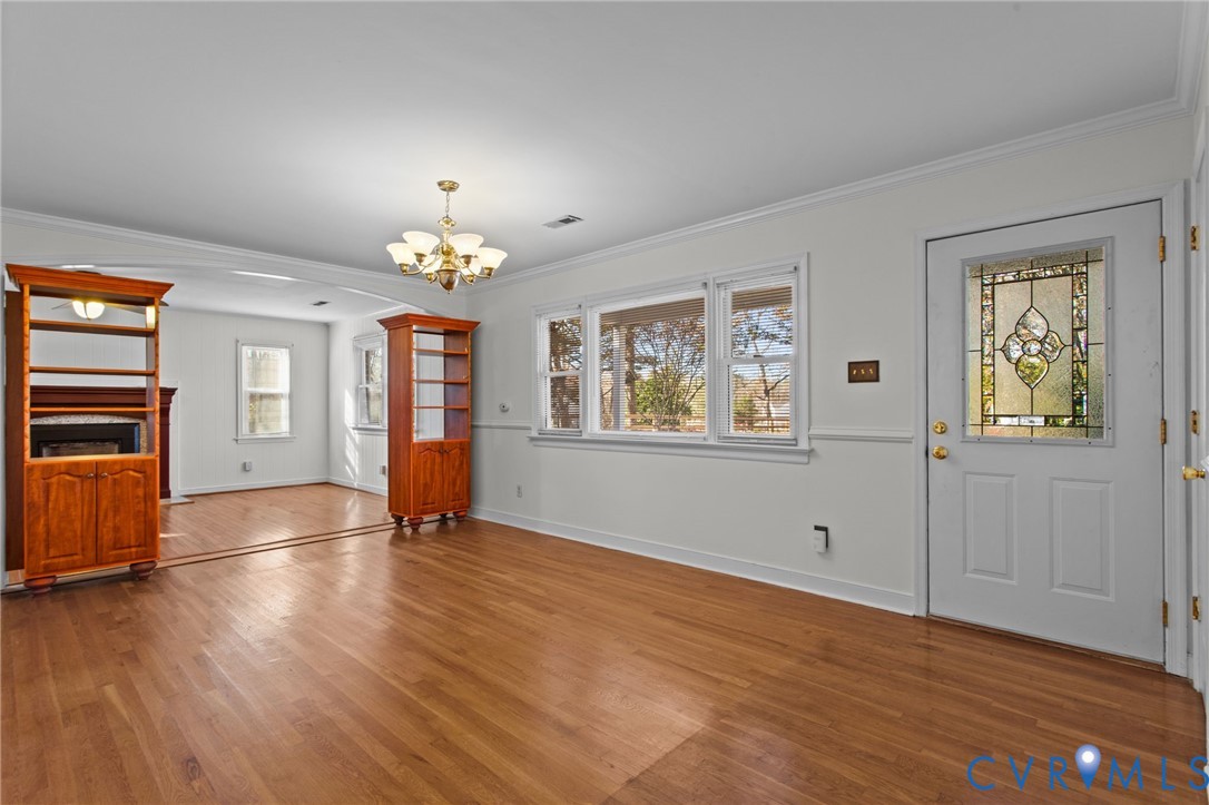 5359 Qualla Road Chesterfield, VA 23832 - Photo 7 of 49 an empty room with wooden floor chandelier and windows
