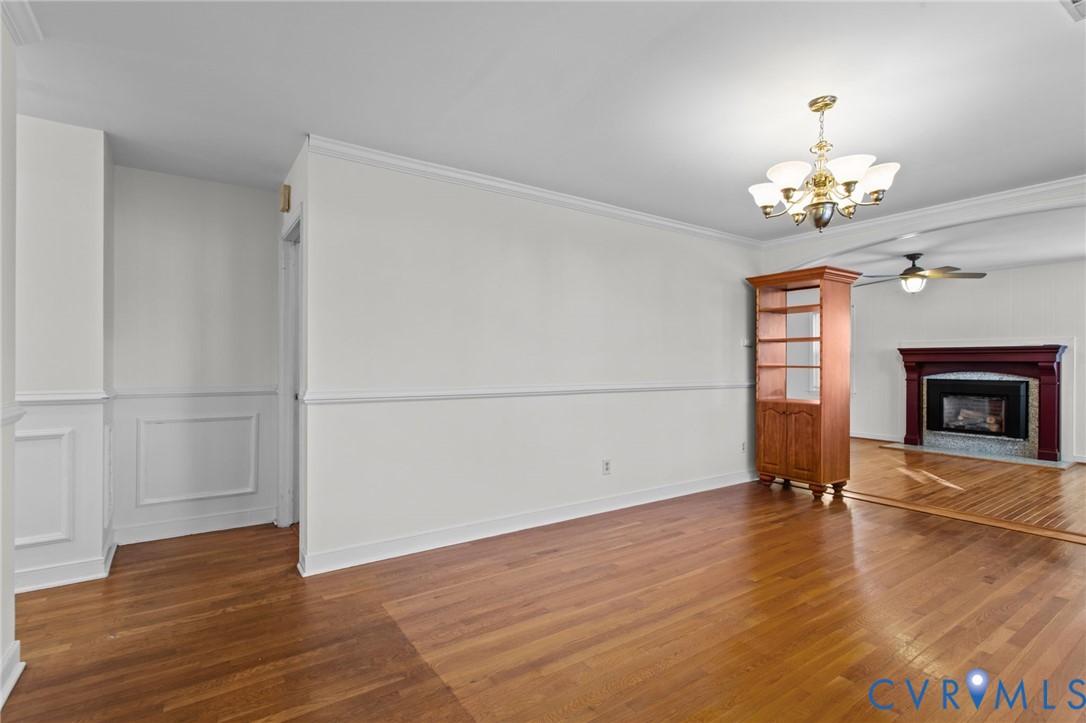 5359 Qualla Road Chesterfield, VA 23832 - Photo 8 of 49 an empty room with wooden floor fireplace and windows