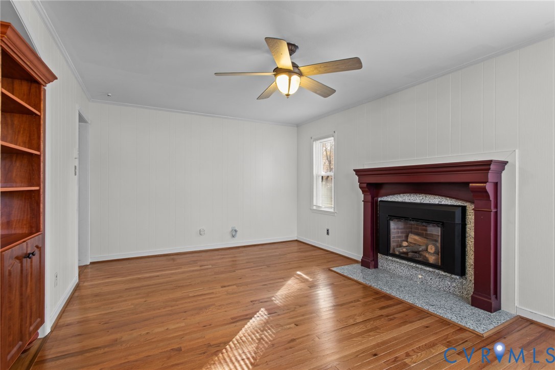 5359 Qualla Road Chesterfield, VA 23832 - Photo 10 of 49 a view of an empty room with wooden floor fireplace and a window