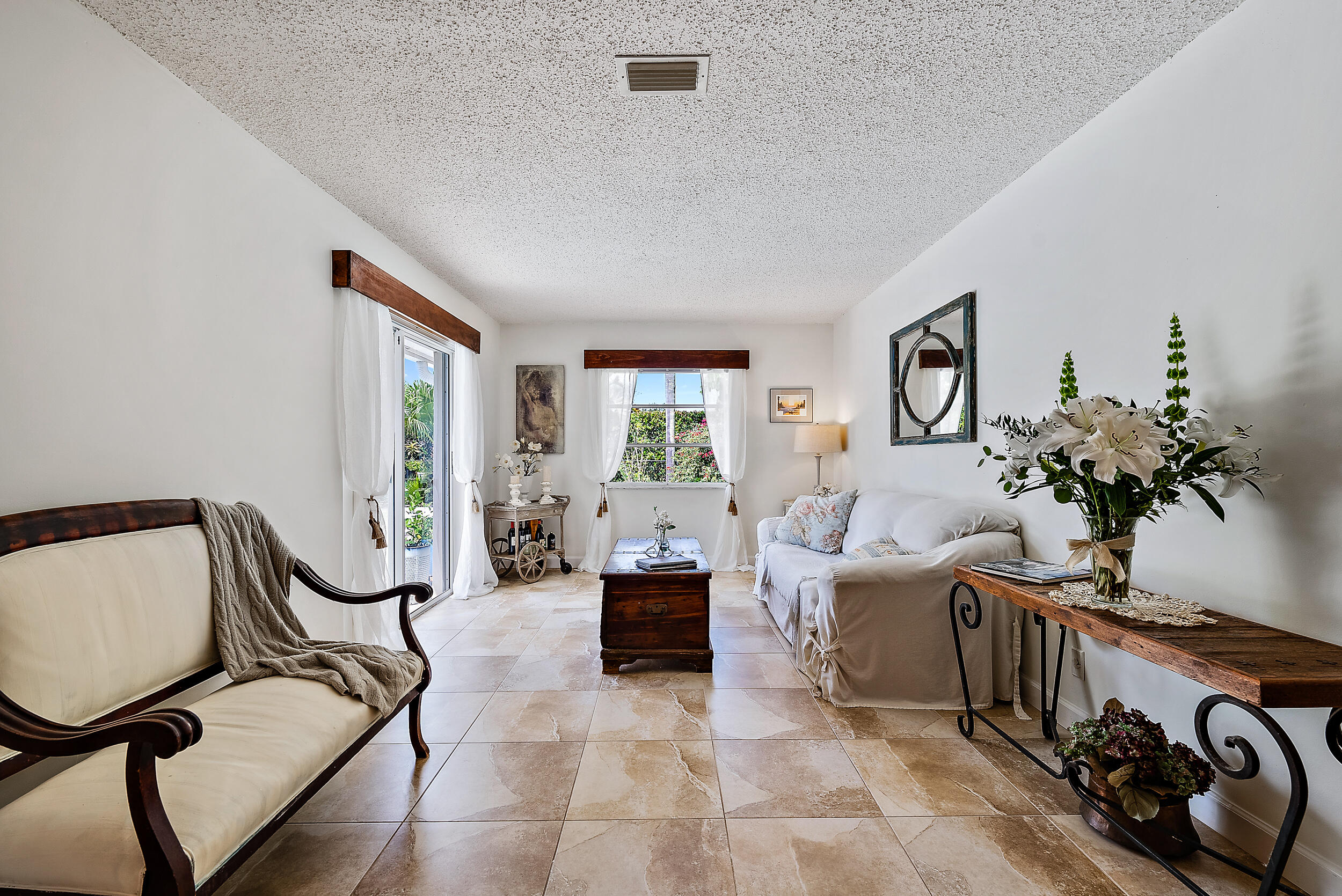 83 Fairview West Tequesta, FL 33469 - Photo 12 of 32 a living room with furniture flowerpot and a window