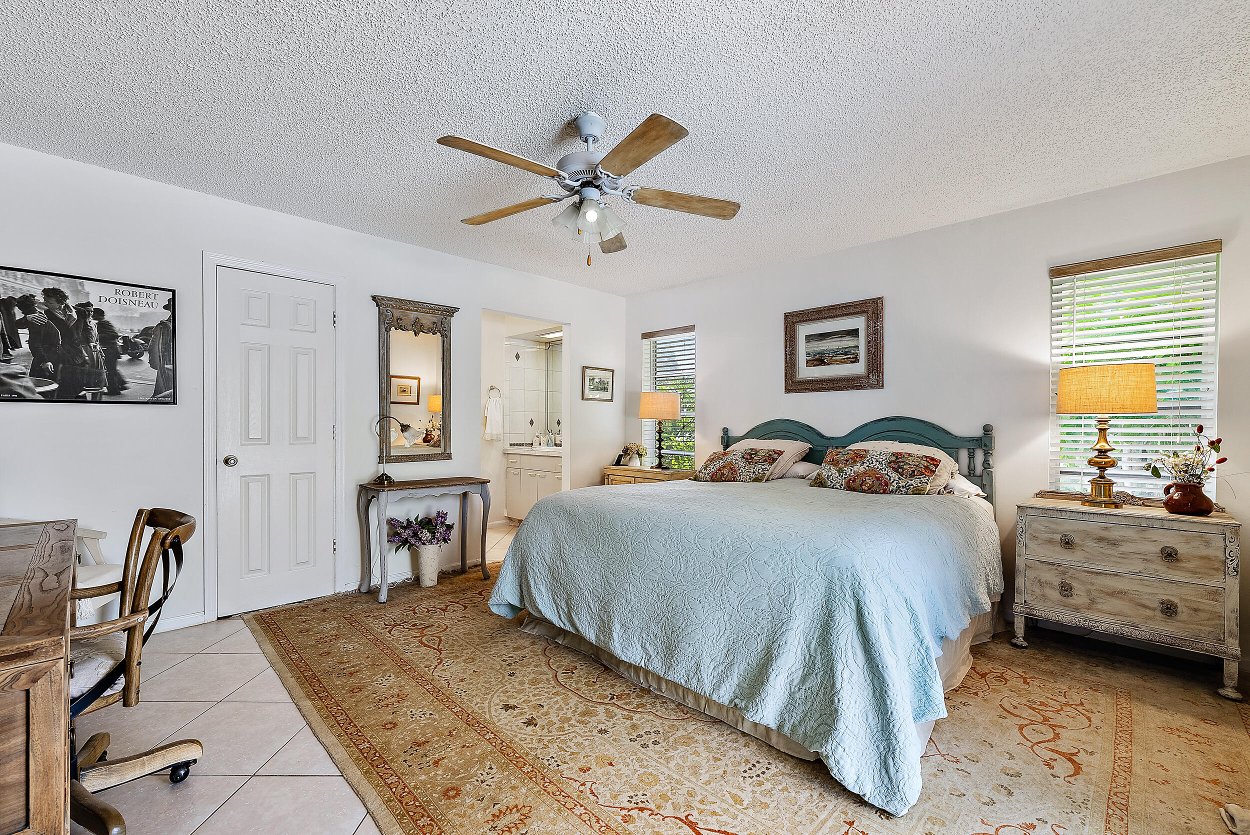 83 Fairview West Tequesta, FL 33469 - Photo 14 of 32 a bedroom with bed a table and chair