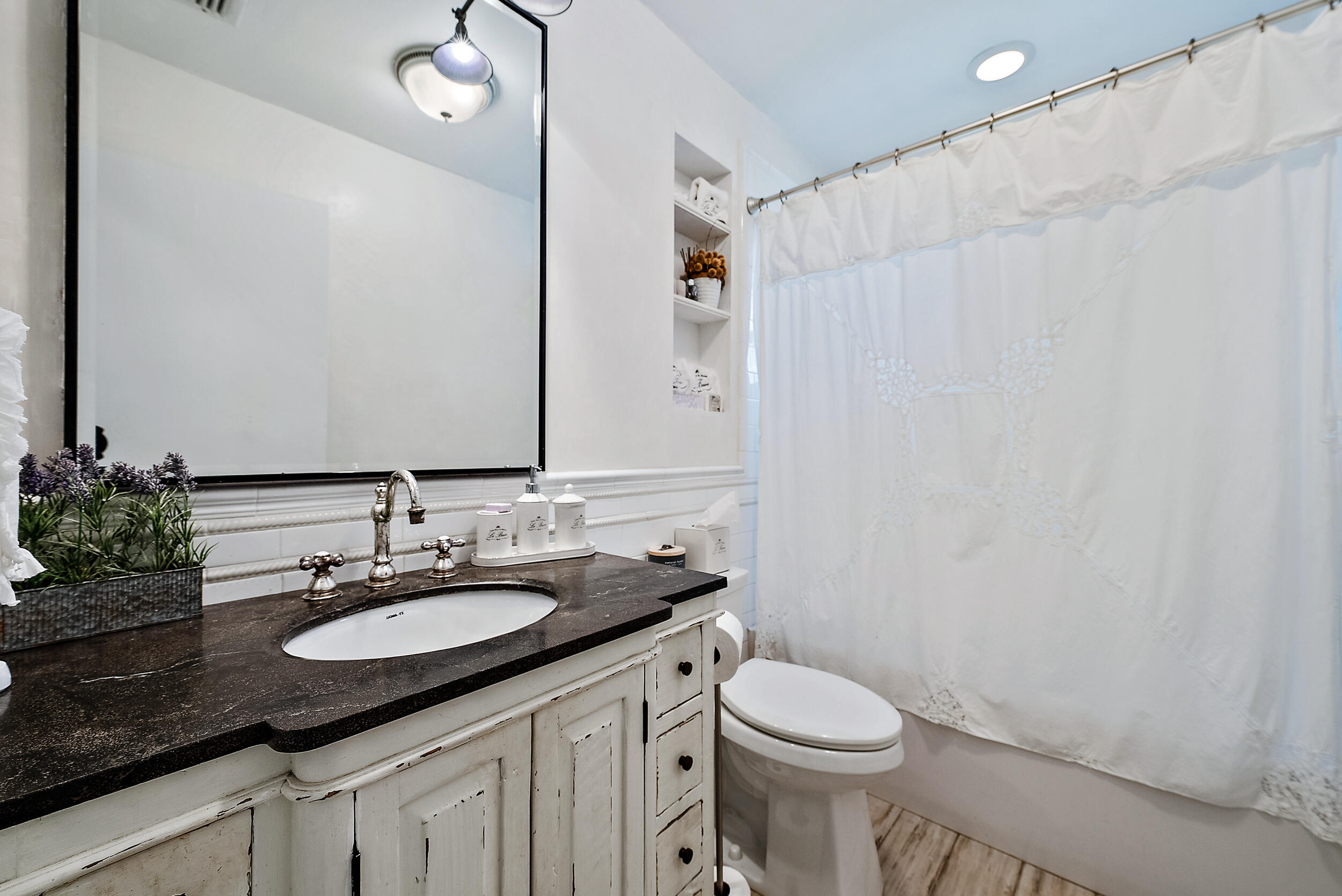 83 Fairview West Tequesta, FL 33469 - Photo 18 of 32 a bathroom with a granite countertop sink toilet and a mirror