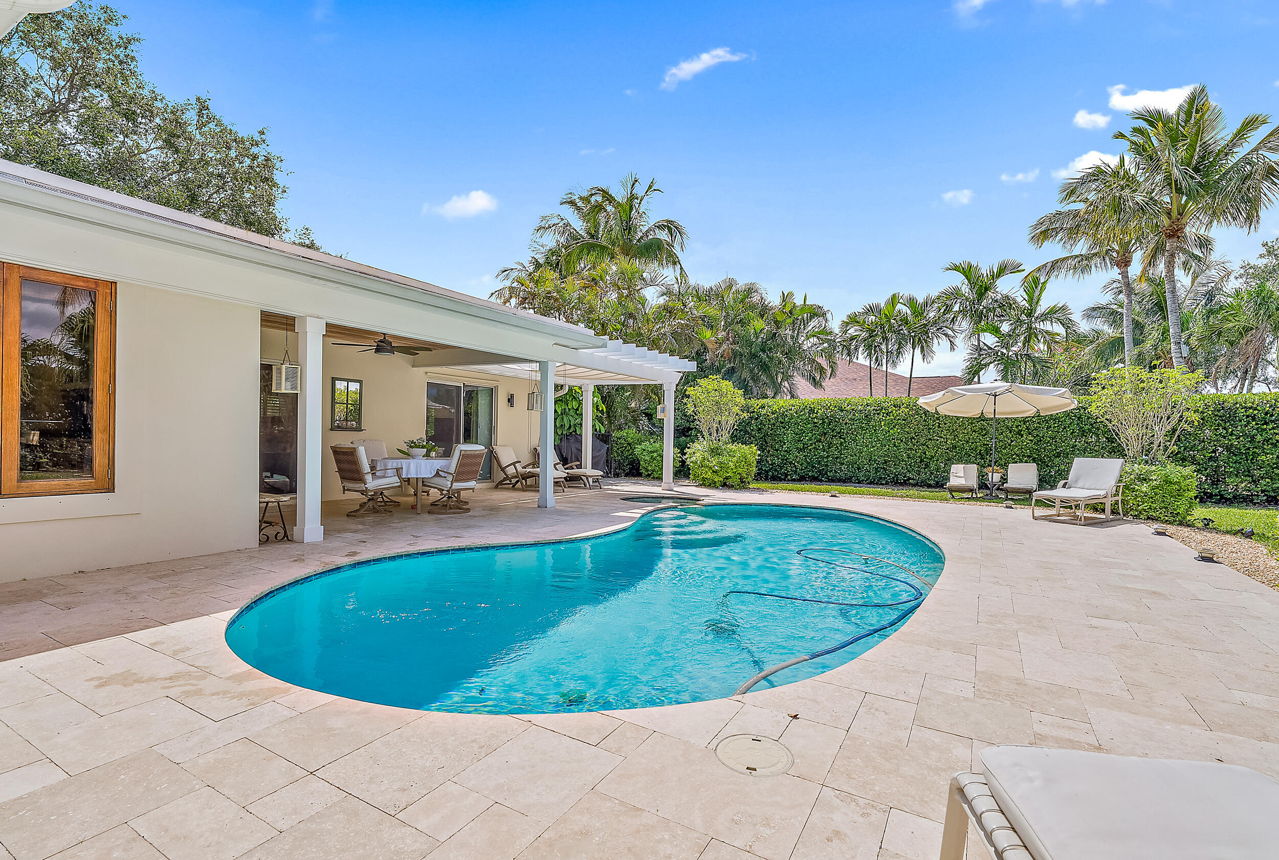 83 Fairview West Tequesta, FL 33469 - Photo 20 of 32 a view of a swimming pool with a patio