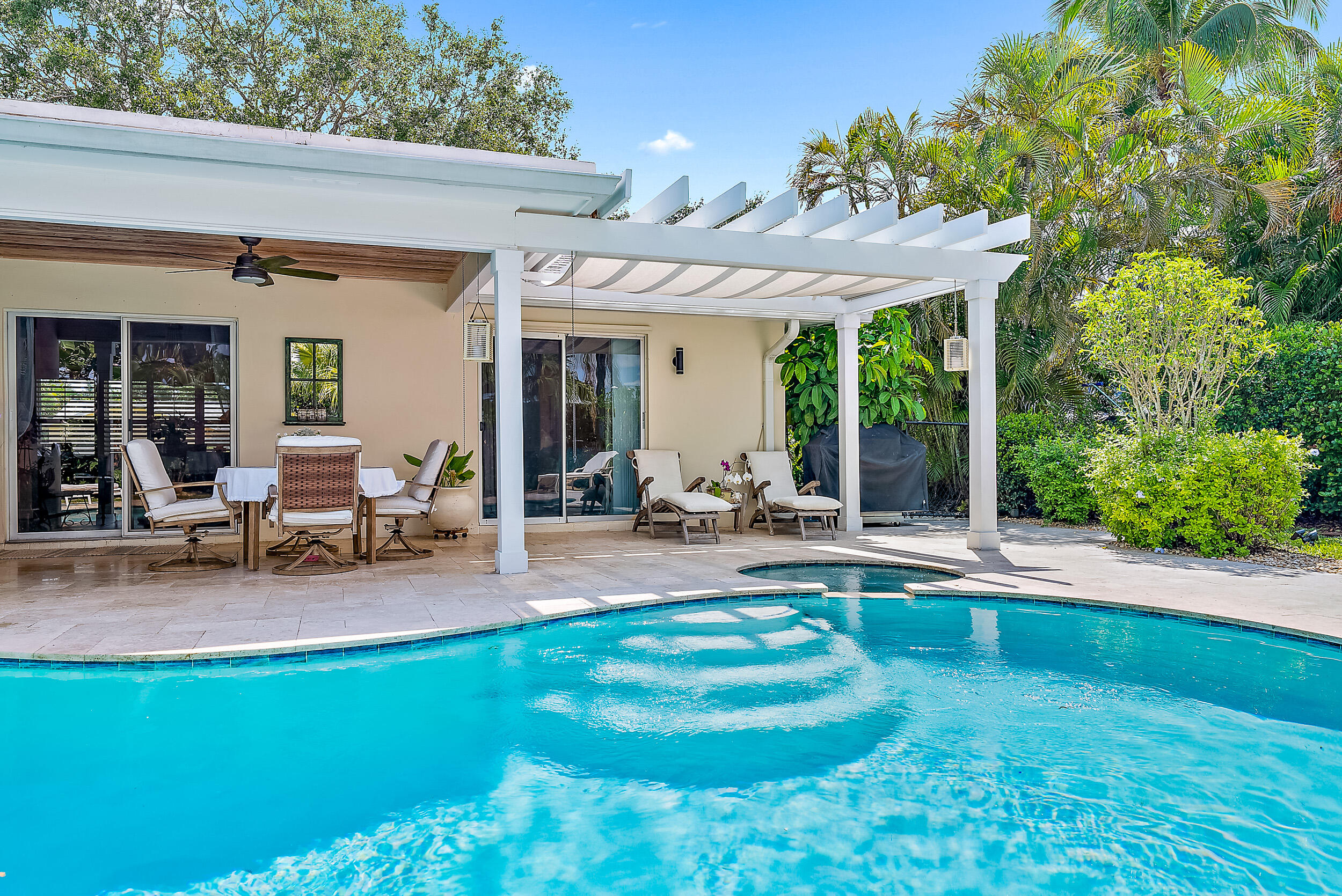 83 Fairview West Tequesta, FL 33469 - Photo 21 of 32 a view of a house with backyard porch and sitting area