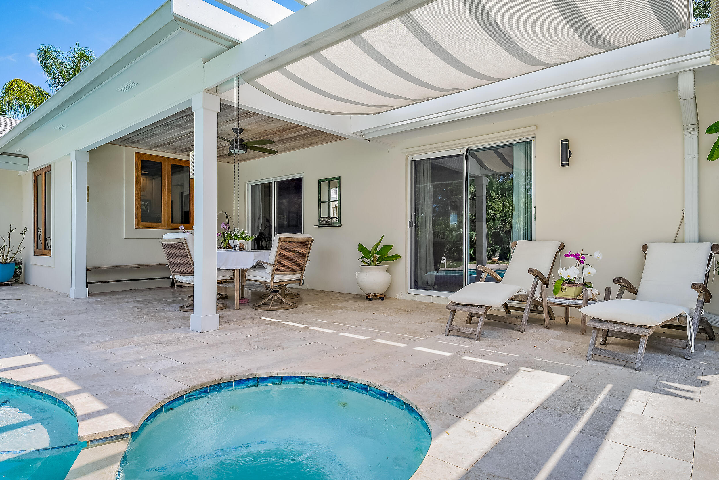 83 Fairview West Tequesta, FL 33469 - Photo 22 of 32 a view of a patio with table and chairs and potted plants
