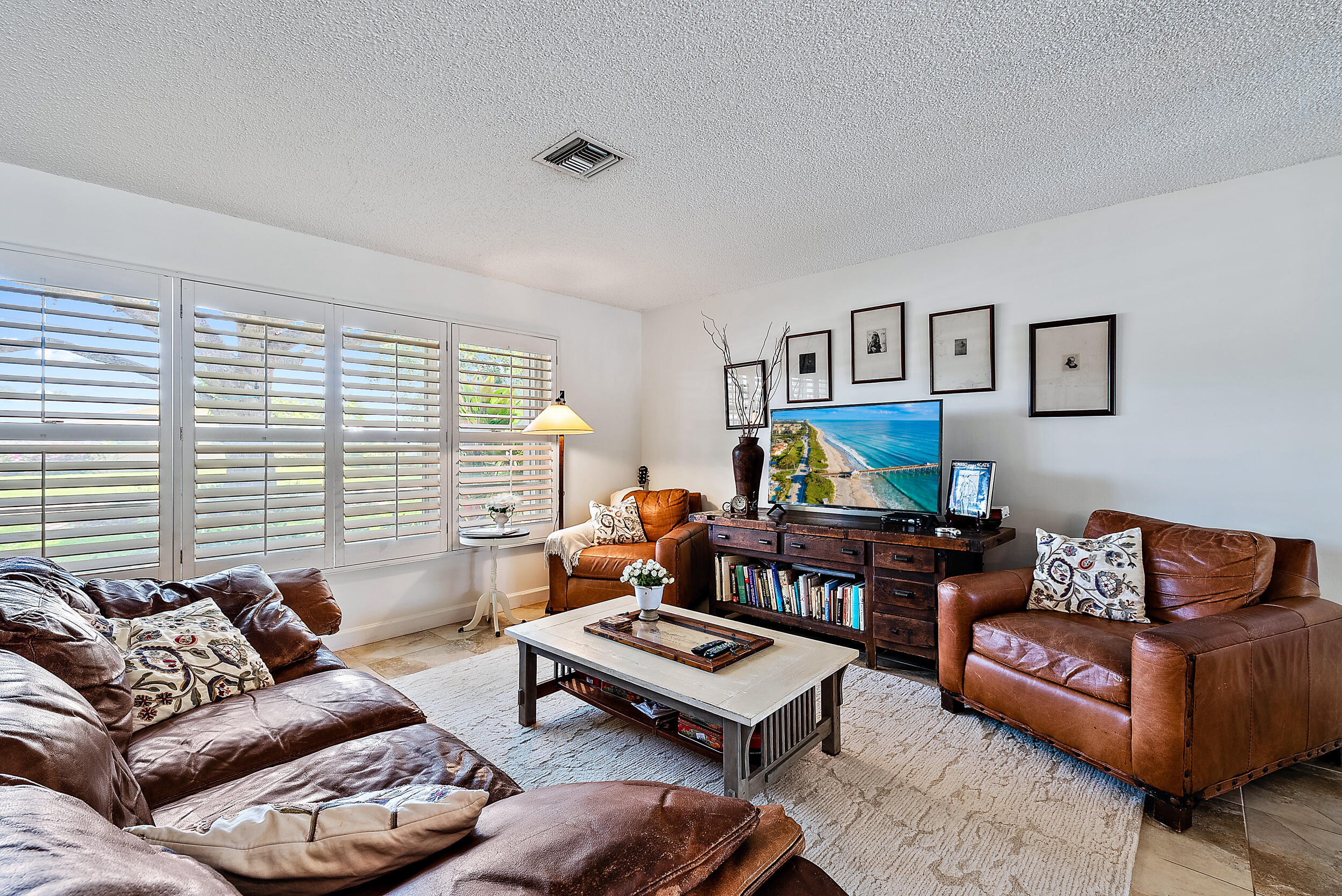 83 Fairview West Tequesta, FL 33469 - Photo 4 of 32 a living room with furniture a rug and a window