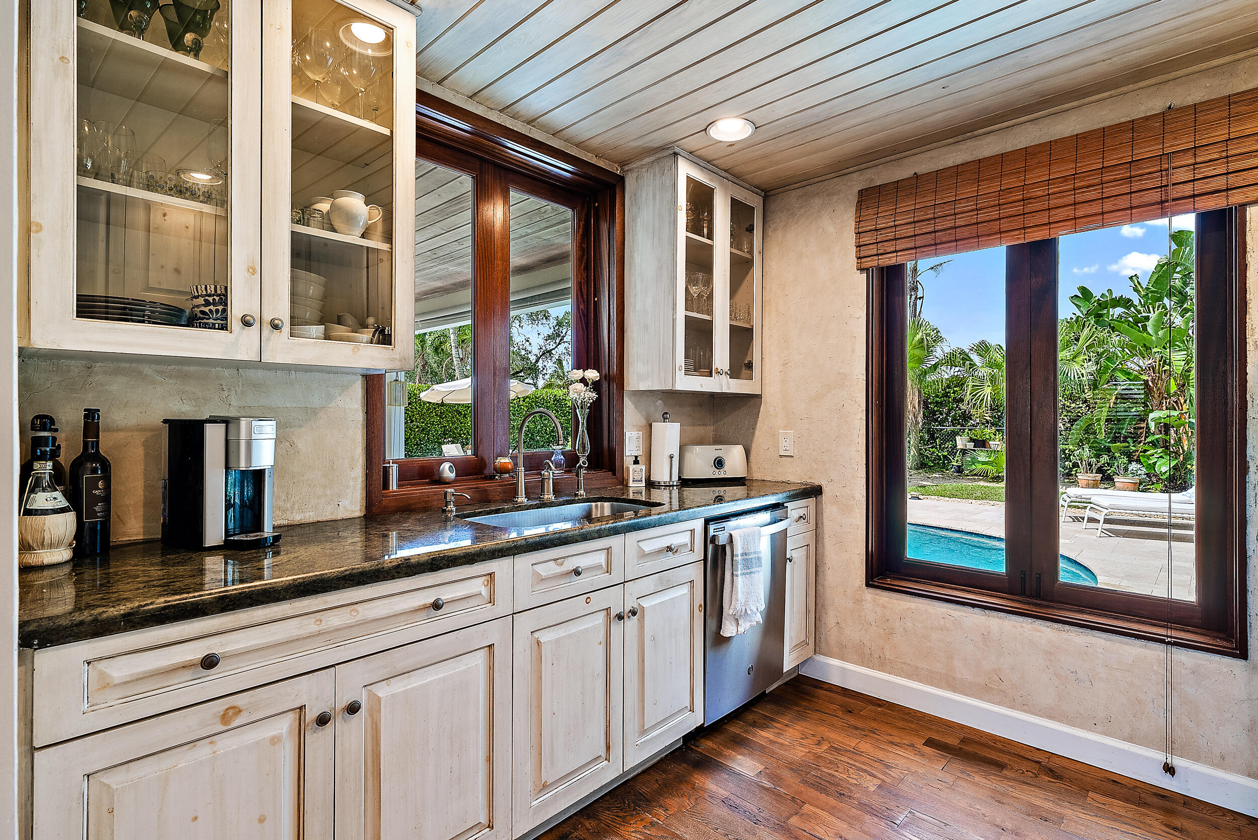 83 Fairview West Tequesta, FL 33469 - Photo 7 of 32 a kitchen with stainless steel appliances granite countertop a stove a sink and a large window