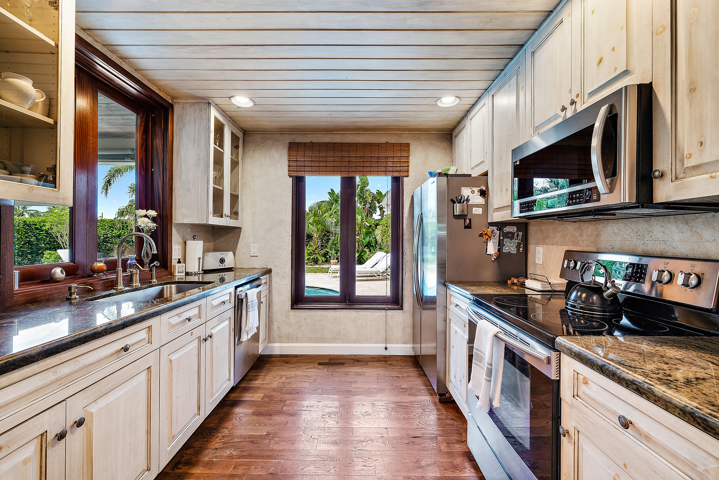 83 Fairview West Tequesta, FL 33469 - Photo 8 of 32 a kitchen with stainless steel appliances granite countertop a stove a sink and a refrigerator
