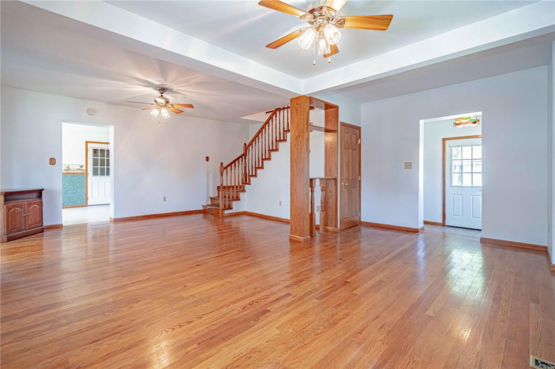 4165 East Texas Road Allentown, PA 18103 - Photo 11 of 56 Natural hardwood flooring guides you through this generously proportioned living area with a classic wooden staircase.