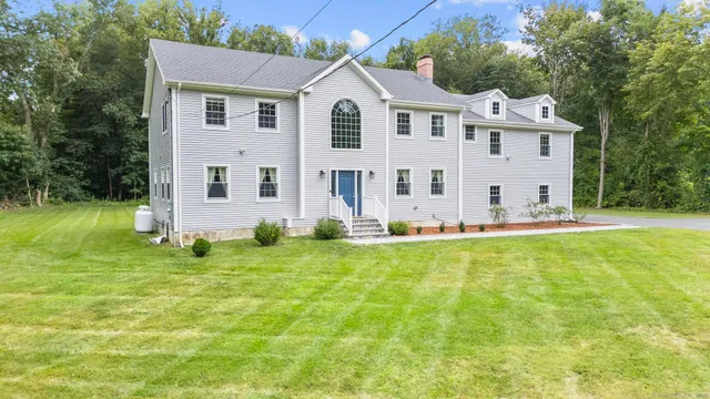 a front view of a house with a yard