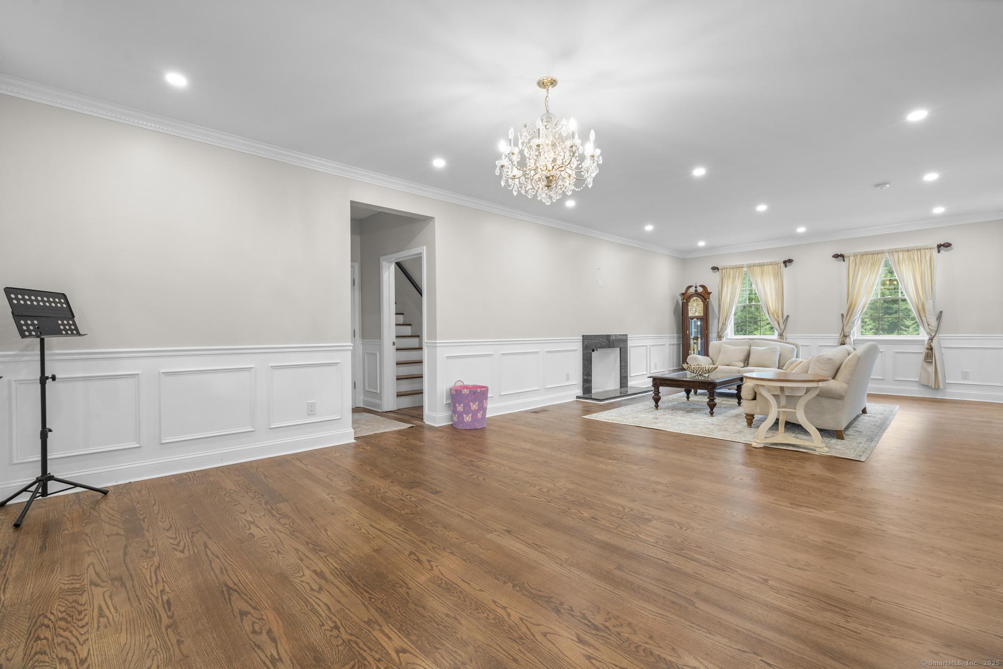 424 Racebrook Road Orange, CT 06477 - Photo 11 of 36 a view of a living room and chandelier in the room