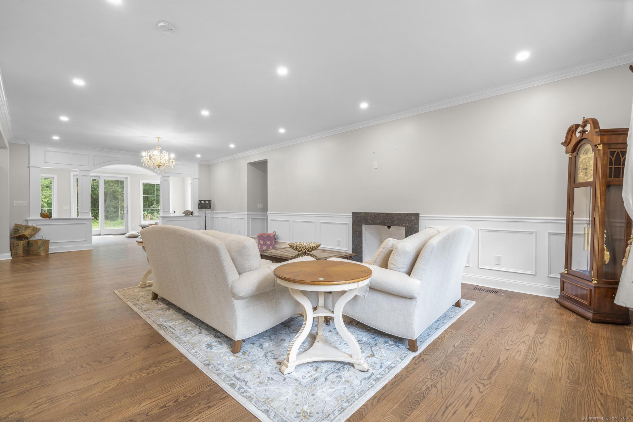 424 Racebrook Road Orange, CT 06477 - Photo 12 of 36 a living room with furniture a wooden floor and a large window