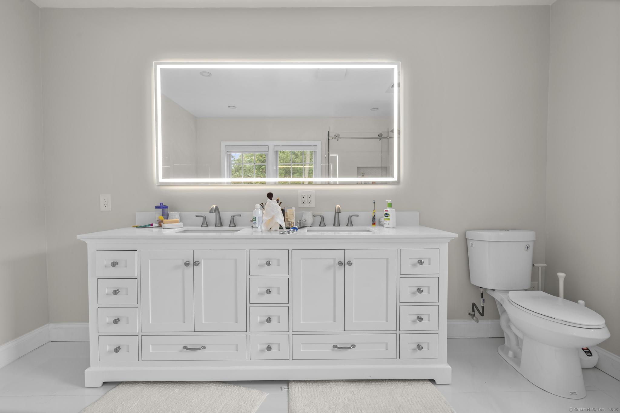 424 Racebrook Road Orange, CT 06477 - Photo 15 of 36 a bathroom with double vanity sink a toilet and a mirror