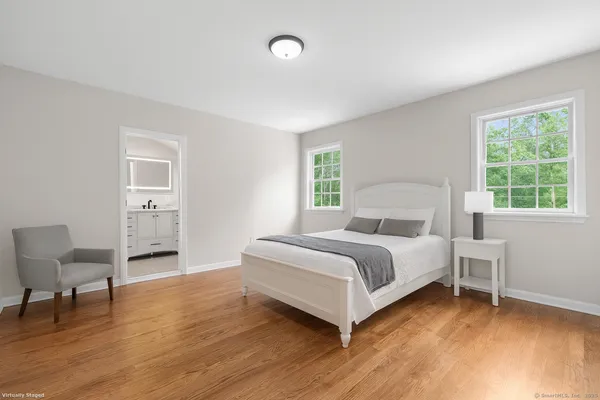 a bed room with a bed and a chair